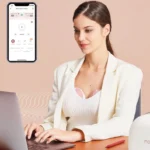 Frau im Büro die freihändige Milchpumpe trägt
